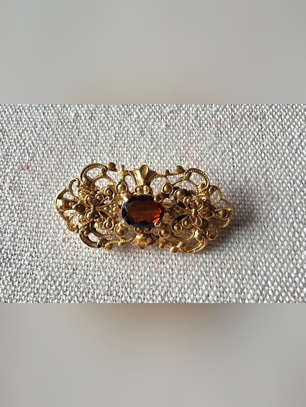 Ornate Gold-Tone Filigree Brooch with Smokey Quartz Color Glass